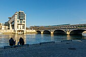 France, Paris, riverbanks of the Seine river listed as World Heritage by UNESCO, building hosting the Ministry of Finances and Economy by architects Paul Chemetov and Borja Huidobro, Bercy bridge over the Seine river and the metro of line 6