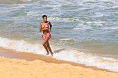 Brazil, state of Bahia, Porto Seguro, beach of Santa Cruz Cabrália, girl walking out of the sea