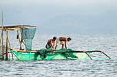 Philippines, Palawan, Malampaya Sound Protected Landscape and Seascape, fishers pulling fish nets