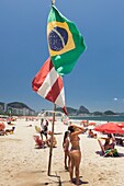 Brazil, state of Rio de Janeiro, city of Rio de Janeiro, Copacabana beach, Carioca landscapes between mountain and sea classified UNESCO World Heritage, Brazilian flag and girls using a beach shower