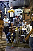 Egypt, Upper Egypt, Aswan, men smoking narghile on the terrace of a souk cafe