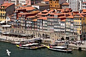 Portugal, North Region, Porto, historical center classified as World Heritage by UNESCO, view from the Dom Luis bridge on the historic Cais de Ribeira district on the banks of the Douro River, boats at the pier