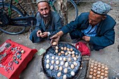 China, Xinjiang autonomous region, Hotan, bazaar, market, hard boiled eggs vendor