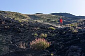 Italy, Sicily, Mount Etna Regional Nature Park, Mount Etna, UNESCO World Heritage Site, North Slope, woman practicing hiking