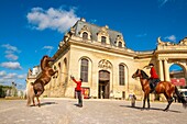 France, Oise, Chantilly, Chateau de Chantilly, the Grandes Ecuries (Great Stables), in front of the entrance Clara makes up his horse