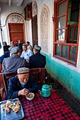 China, Xinjiang autonomous region, Kashgar, typical breakfast of bread and tea in a restaurant tea-house sit on a balcony