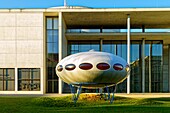 Germany, Bavaria, Munich, the Futuro House, round prefabricated house of the shape of a flying saucer designed in 1968 by Finnish architect Matti Suuronen in front of the Modern Art Pinacotheca (Pinakothek der Moderne) inaugurated in 2002 by the architect Stefan Braunfels