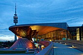 Germany, Bavaria, Munich, BMW Welt, showroom of the brand native from Munich opened in 2007 and realized by the architect firm Coop Himmelb(l)au and the Olympic tower or Olympiaturm