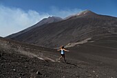 Italy, Sicily, Mount Etna Regional Nature Park, Mount Etna, UNESCO World Heritage Site, North Slope, eruption of July 27, 2019, woman practicing running