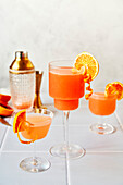 Blood orange margaritas on a tiled table with a grey background