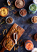 Selection of dried and canned legumes, and pasta made from legumes for plant-based whole food diet.