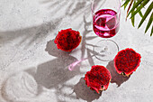 Glass of cocktail,dragon fruit,also called pitaya,sliced pink magenta flesh with tiny black seeds,tropical fruit
