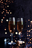 Champagne Celebration on Dark Background with Bokeh Lights, with Negative Space.