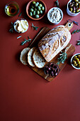 Selection of olive products, including Kalamata olive sourdough bread, green olive dip, olive oil, dairy-free olive spread, Sicilian olives and marinated green and black olives