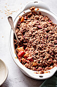 Apple rhubarb crisp in an oval baking dish