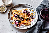 Paleo gluten-free almond flour crepes with berry compote and cream