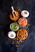 Yellow and green dried split peas, red lentils and pasta made from legumes for plant-based whole food diet.