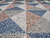 Portugal, Lisbon. Typical Portuguese colorful cobblestone pavement.