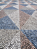 Portugal, Lisbon. Typical Portuguese colorful cobblestone pavement.