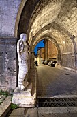 Roman toga-wearing statue from the forum area, Bell tower and arch of St. Peter, Isernia, Molise, Italy, Europe