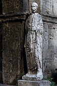 Roman toga-wearing statue from the forum area, Bell tower and arch of St. Peter, Isernia, Molise, Italy, Europe