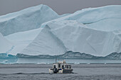 Little boat between the icebergs of the Ilulissat Icefjord, UNESCO World Heritage Site, Western Greenland, Denmark, Polar Regions