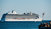 Giant leisure cruise ship on the Tagus River, with people in the foreground, Lisbon, Portugal, Europe