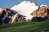 Snow-capped peaks rise above green Valleys in beautiful Kyrgyzstan, Central Asia, Asia