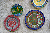 Colorful ceramic plates on display on wall inside ceramic store, Avanos, Cappadocia, Central Anatolia Region, Anatolia, Turkey, Asia Minor, Asia