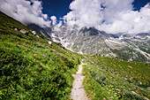 Hiking trail in alpine landscape facing Monte Rosa with moraine landscape, Italian Alps, Italy, Europe