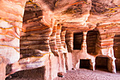 Sandstone caves, multicoloured due to various oxides, containing carved tombs, historic and archaeological Nabataean city of Petra, UNESCO World Heritage Site, Jordan, Middle East