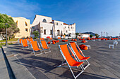 View of town hall and brightly coloured deckchairs, Forio, Island of Ischia, Campania, Italy, Europe