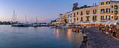 View of restaurants in Porto d'Ischia (Port of Ischia) at dusk, Island of Ischia, Campania, Italy, Europe