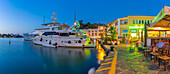 View of boats and restaurants in Porto d'Ischia (Port of Ischia) at dusk, Island of Ischia, Campania, Italy, Europe