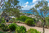 View of tropical flora in Giardini la Mortella Botanical Gardens and Forio in background, Forio, Island of Ischia, Campania, Italy, Europe