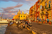 View of Church of Santa Maria della Pieta in the fishing port Marina Grande with shops at golden hour, Procida, Phlegraean Islands, Gulf of Naples, Campania, Southern Italy, Italy, Europe