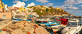 View of fishing nets and boats in Marina di Corricella and Church of Santa Maria delle Grazie in background, Procida, Phlegraean Islands, Gulf of Naples, Campania, Southern Italy, Italy, Europe