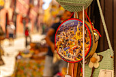 View of colourful souvenir tambourine in narrow backstreet in the fishing port, Procida, Phlegraean Islands, Gulf of Naples, Campania, Southern Italy, Italy, Europe