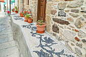 Pebble mosaic and potted plants, Old town, Mandraki, Nisyros Island, Dodecanese Islands, Greek Islands, Greece, Europe