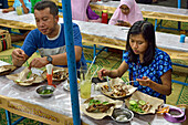 Open-air street side restaurant (lesehan) by night on Malioboro Street, major shopping street in Yogyakarta, Java island, Indonesia, Southeast Asia, Asia