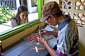 Workshop of copper plate stamps (cap) used to apply wax-resist to make pattern before dyeing in batik process, Sondakan district, Solo (Surakarta), Java island, Indonesia, Southeast Asia, Asia