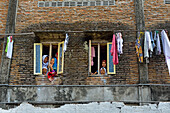 School girls at the window of a high school dormitory, Lasem, Java island, Indonesia, Southeast Asia, Asia