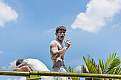 Man unloading sacks of flour off a truck on the road from Semarang to Juwana, Java island, Indonesia, Southeast Asia, Asia