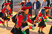 Peruvian women in traditional dresses dancing on celebration, Chinchero, Peru, South America