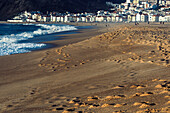 Selective focus view of the beach with fishing town of Nazare in the background, known for the largest waves in the world, Nazare, Oeste, Estremadura, Portugal, Europe