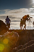 The endemic Galapagos marine iguana (Amblyrhynchus cristatus) with tourists in the background, Galapagos Island Archipelago, UNESCO World Heritage Site, Ecuador, South America