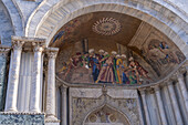 Mosaic art in a lunette on the facade of St. Mark's Basilica in Venice, Italy. This mosaic depicts the recovery of the relics of St. Mark from Egypt to Venice.