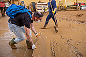 People cleaning. Effects of the DANA floods of October 29, 2024, Pelayo street, Paiporta, Comunidad de Valencia, Spain