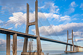 The impressive Vasco da Gama bridge stretches across the Tagus River, showcasing modern engineering and scenic views of Lisbon.