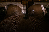 Aerial night view of an abundant Ebro River passing under the Stone Bridge after the Dana, Zaragoza, Spain